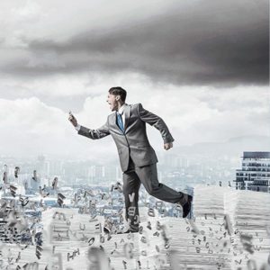 An accountant is running through numbers and paperwork stacks with city in the background